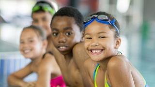 Children at pool smiling