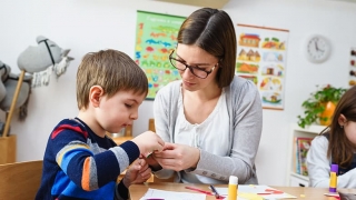 Teacher with child in classroom