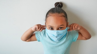 Young girl wearing protective face mask