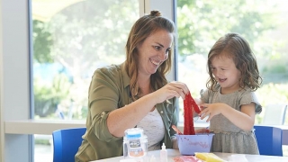 Mom making slime putty with daughter