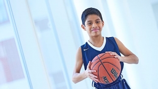 Young boy in his basketball uniform