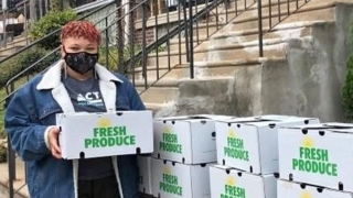 Junior Block Captain distributing fresh food boxes to neighbors, Photo Credit: Urban Tree Connection