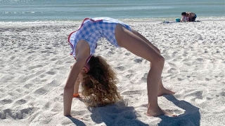 Katie Grace doing flips on the beach