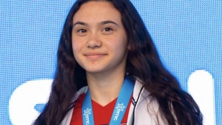 Maia wearing a gold medal