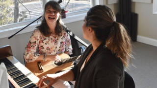 Cerebral palsy patient playing guitar in music therapy class