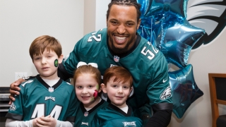 Najee Goode poses with kids at the 8th annual Huddle Up for Autism