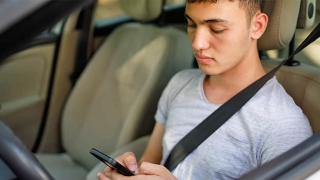 Teen driver looking at phone