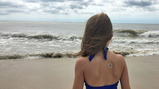 Girl on beach wearing patch