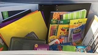Box full of donated school supplies