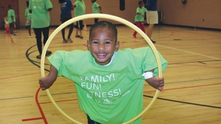 Young boy playing with a hula hoop