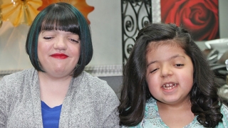 Two girls smiling with new haircuts