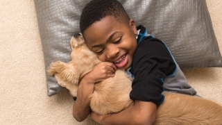 Zion hugging a puppy
