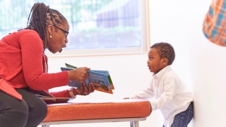 Mom reading to a young child
