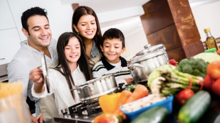 Family in kitchen cooking healthy meal together