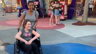 Sophia being pushed in her wheelchair