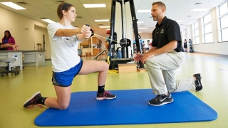 Physical therapist stretching out patient