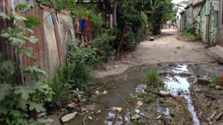 Standing water and trash in a lower socio-economic neighborhood in Consuelo - a community that fellows like Dr. Turner help care for.