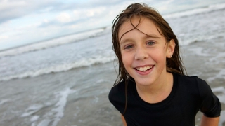 girl on beach smiling