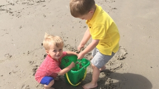 Tristan at the beach with his brother playing in the sand
