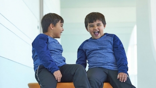 Twin brothers laughing together