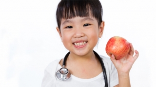 girl holding apple