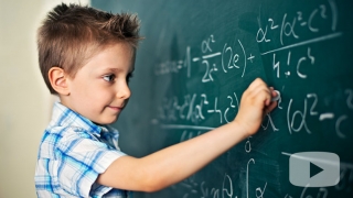 Young boy using chalkboard