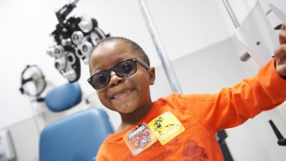 Child with glasses in ophthalmologist's office