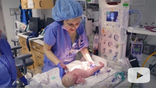Nurse holding newborn