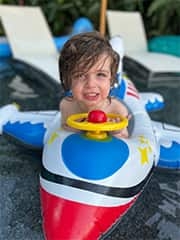 Alexander on an airplane floaty