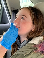 Girl getting nose swabbed for COVID-19 testing
