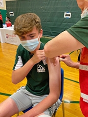 Teen boy receiving vaccine