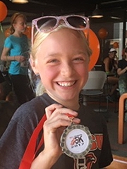 Andrea holding her race medal