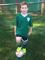 Jacob smiling in his soccer uniform