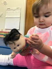 Kaylee playing with her doll