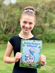 Maille holding Buddy Booby's Birthmark children's book
