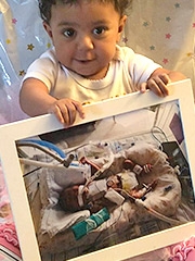 Addison holding a photo of her from the ICU