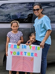 Family with CHOP sign and decorated van