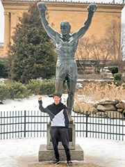 Sam standing in front of the Rocky statue