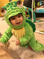 baby boy in dinosaur costume
