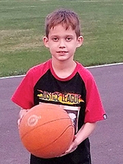 Caoimhghin holding a basketball