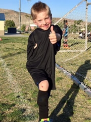 Tayvin on soccer field giving thumbs up