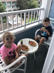boy and girl eating breakfast outside