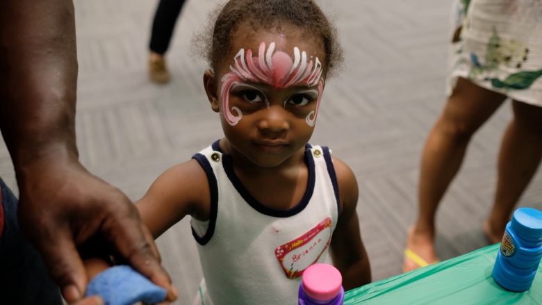 Young girl with face paint at hospital event