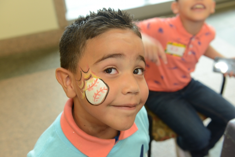 Boy patient at hospital event with baseball face paint