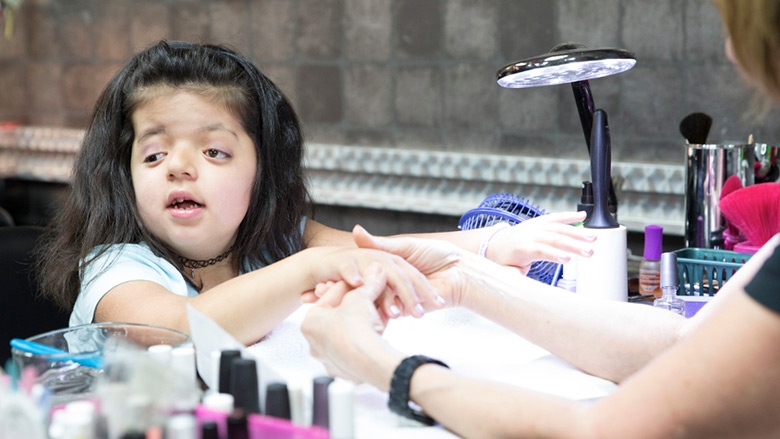 Young girl getting her nails done