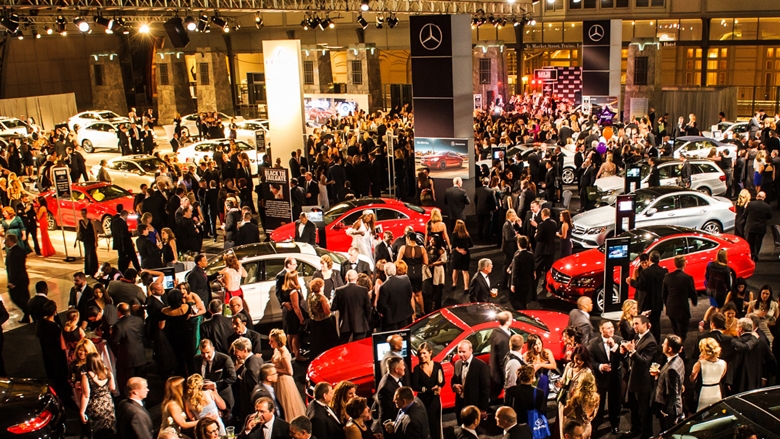 Black Tie Tailgate - People in large room with mercedes