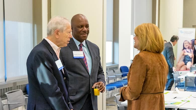 Corporate Council members Angelo Perryman and Carl Dranoff speak with CHOP CEO Madeline Bell