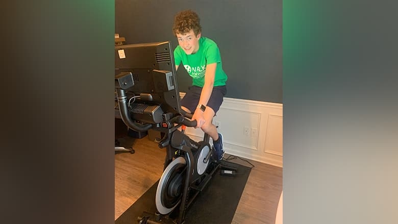 Walk for Hope virtual participant on spin bike