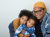 Mother smiling and hugging two young sons