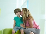 mother kisses her child